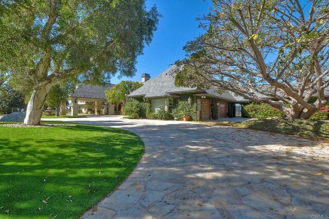 31350 Lake Vista Cir, Bonsall, CA 92003 - view of front facade with curved driveway, a front yard, and a chimney