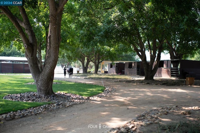 obstructed view of property with an outbuilding