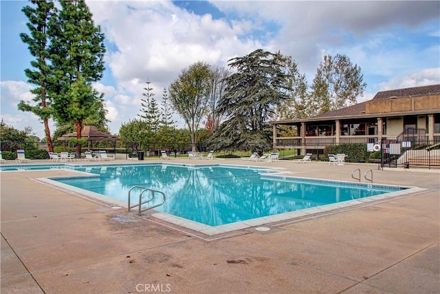 view of swimming pool featuring a patio area