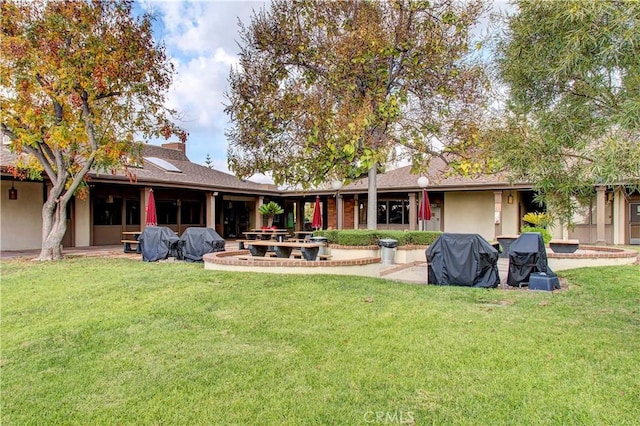 back of house with a patio area and a yard