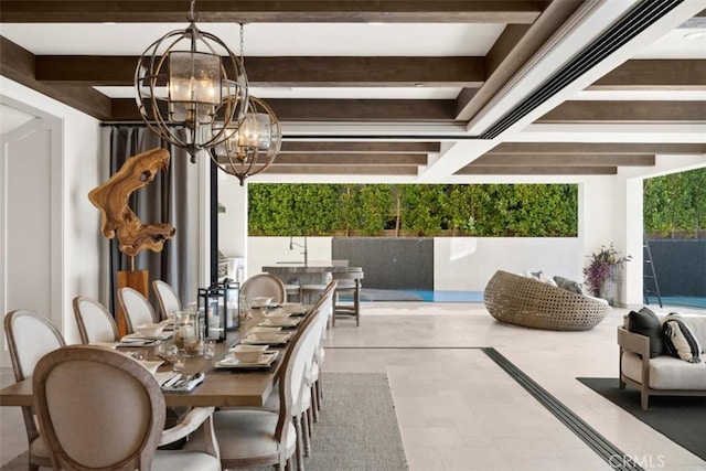 dining room featuring a chandelier and beamed ceiling