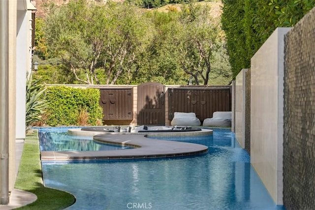 view of pool with a fenced in pool, a gate, and fence