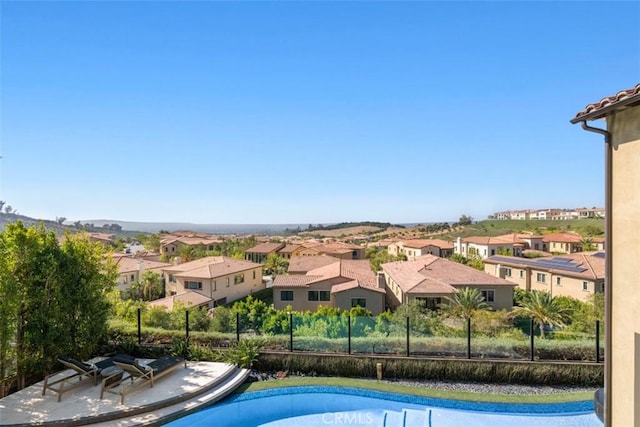 pool with a residential view and fence