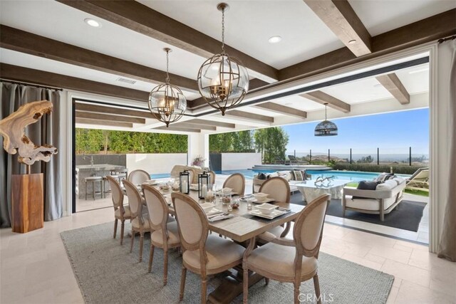 dining space featuring beam ceiling and an inviting chandelier