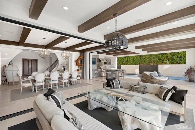 living room with a chandelier, beamed ceiling, and recessed lighting