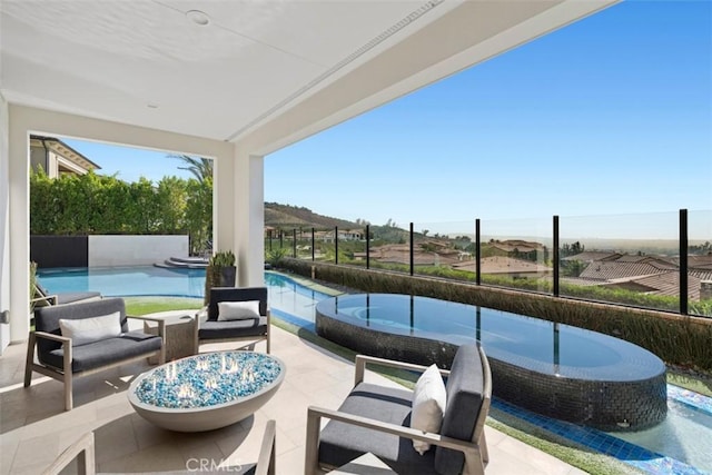 view of patio / terrace featuring an outdoor pool and fence