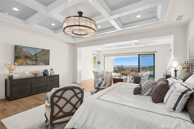 bedroom with a chandelier, light wood finished floors, beamed ceiling, and visible vents