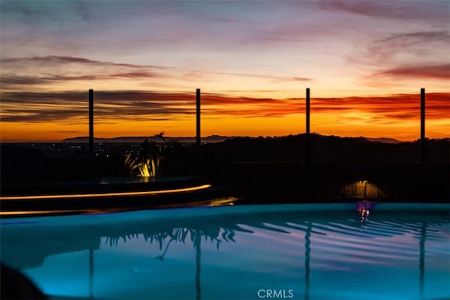 pool at dusk with an outdoor pool