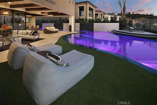 pool featuring a patio area and an outdoor living space