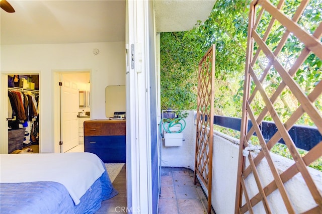 bedroom featuring a closet, tile patterned flooring, and a walk in closet