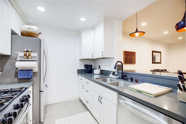 kitchen featuring appliances with stainless steel finishes, white cabinetry, and sink