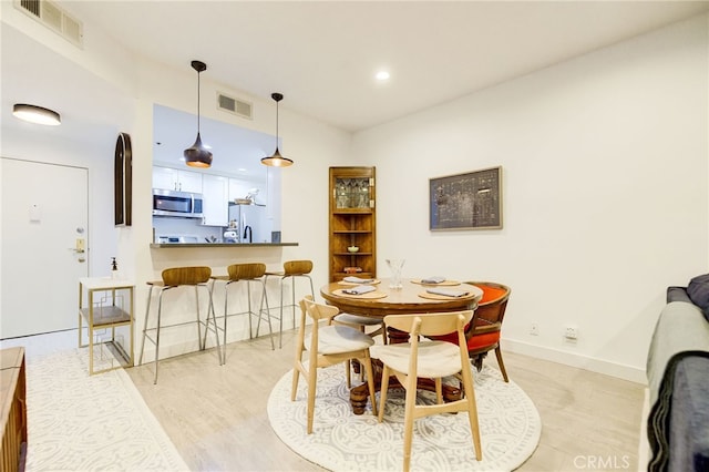 dining space with light wood-type flooring