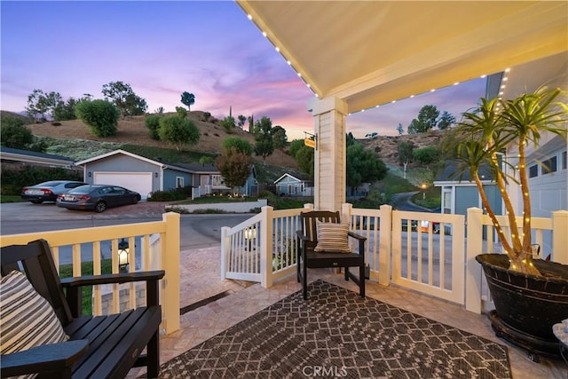 patio terrace at dusk with a garage and an outdoor structure