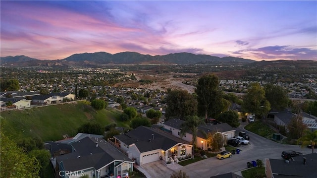 aerial view at dusk featuring a mountain view