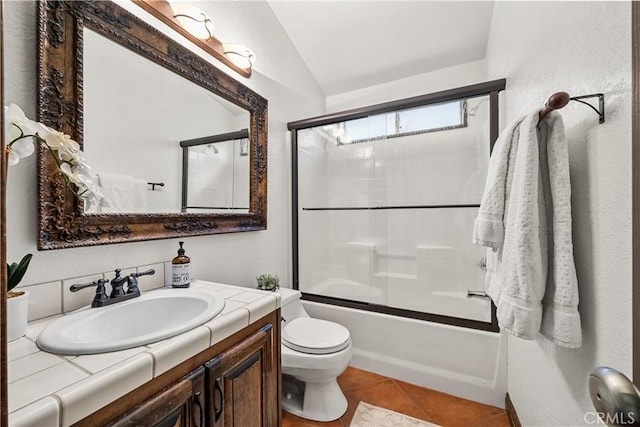 full bathroom featuring tile patterned floors, vanity, vaulted ceiling, shower / bath combination with glass door, and toilet