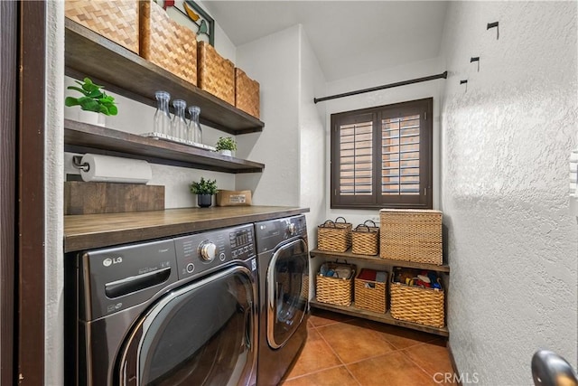 washroom with tile patterned floors and washing machine and dryer