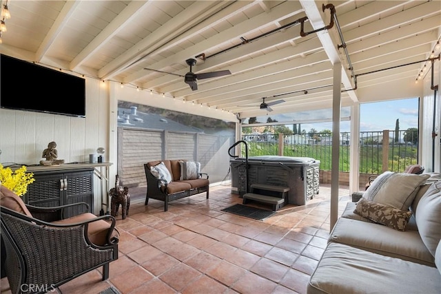 view of patio / terrace featuring ceiling fan and a hot tub