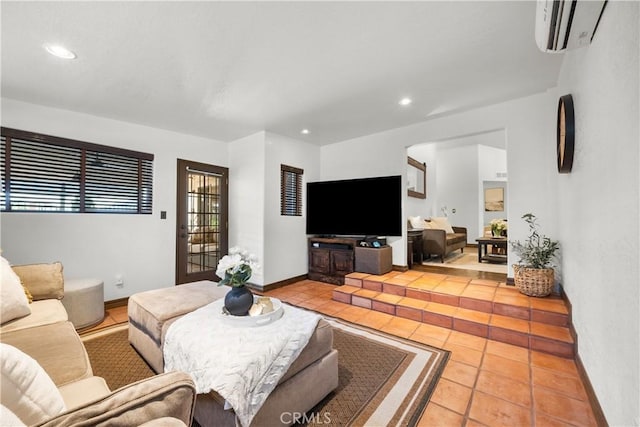 living room with light tile patterned floors and a wall unit AC