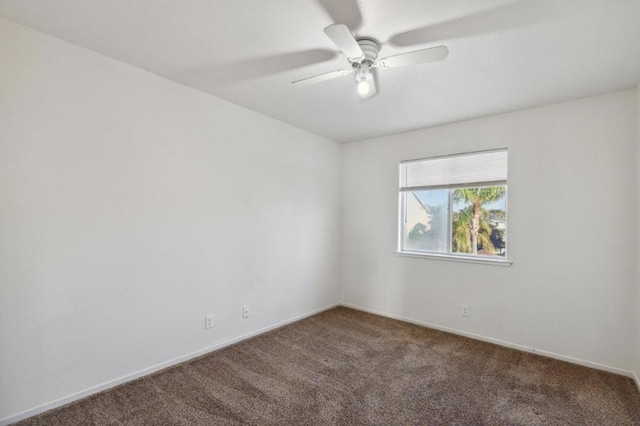 unfurnished room with ceiling fan and carpet