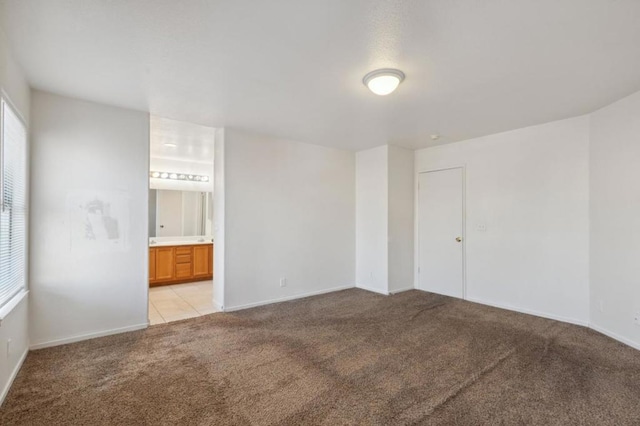 unfurnished room featuring light carpet