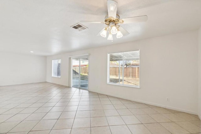 empty room with light tile patterned flooring and ceiling fan