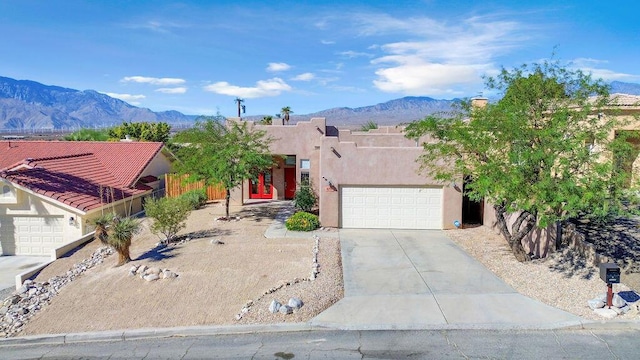 view of front of home with a mountain view and a garage