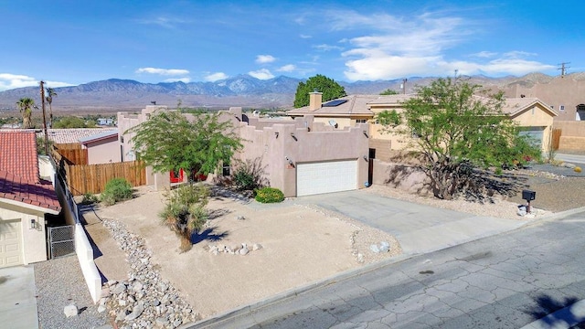 view of front of property featuring a mountain view and a garage