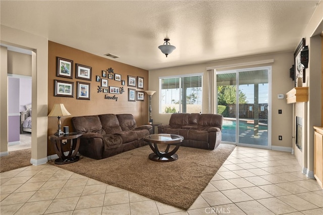 living room with light tile patterned floors and a textured ceiling