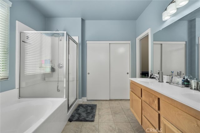 bathroom with tile patterned flooring, vanity, and shower with separate bathtub