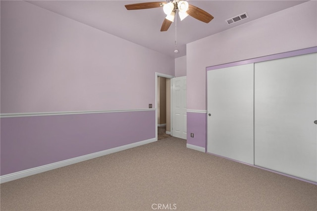 unfurnished bedroom with carpet flooring, a closet, and ceiling fan