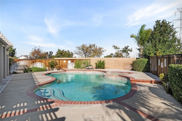 view of pool with an in ground hot tub and a patio