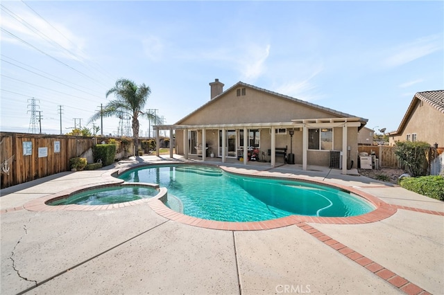 view of swimming pool with a patio area and an in ground hot tub