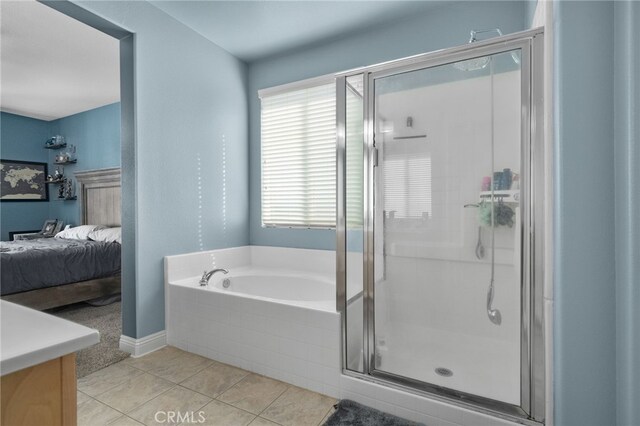 bathroom with tile patterned flooring and separate shower and tub