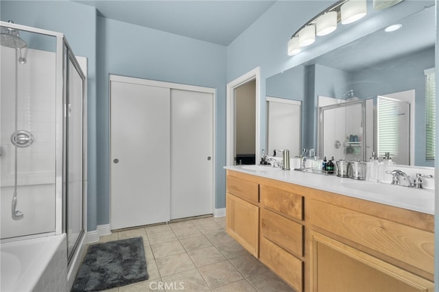 bathroom featuring tile patterned flooring, vanity, and shower with separate bathtub