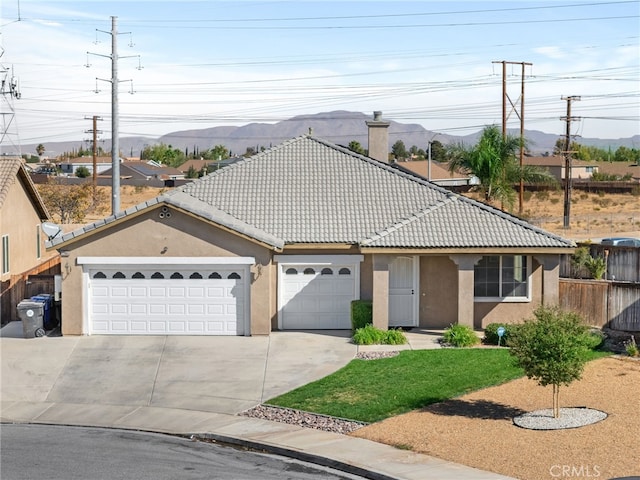 view of front of home with a mountain view and a garage