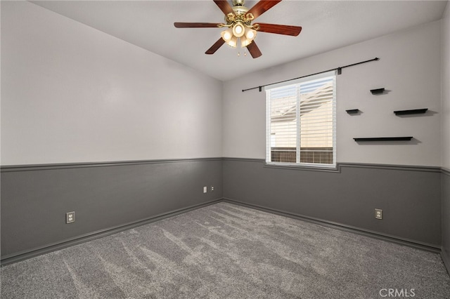 empty room featuring light colored carpet and ceiling fan