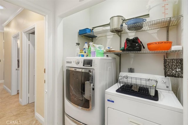 clothes washing area featuring washer and clothes dryer and ornamental molding