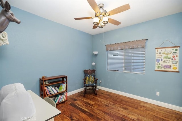 sitting room featuring ceiling fan and dark hardwood / wood-style flooring