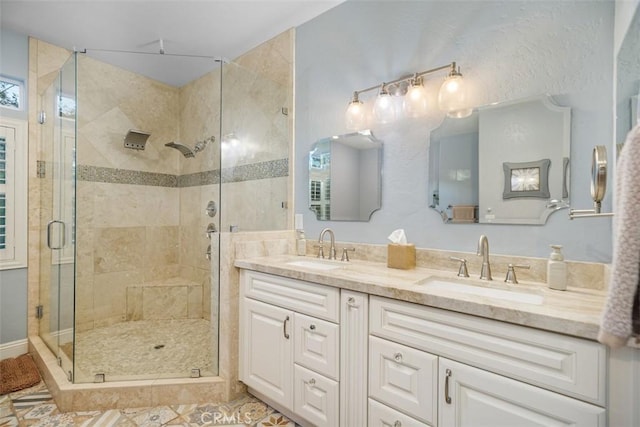 bathroom with vanity and a shower with door