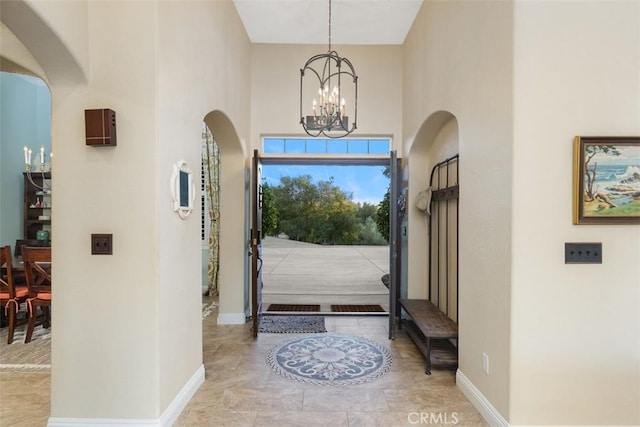 foyer with a high ceiling and an inviting chandelier