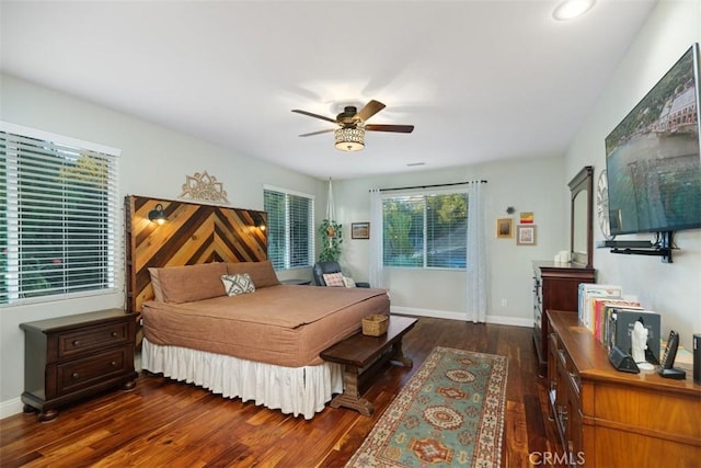 bedroom with dark hardwood / wood-style flooring and ceiling fan