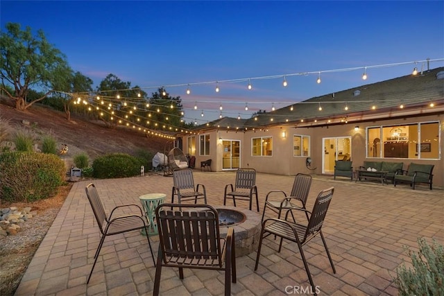 patio terrace at dusk featuring an outdoor fire pit