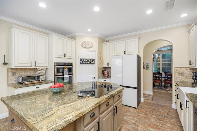 45600 La Cruz Dr, Temecula, CA 92590 - kitchen featuring freestanding refrigerator, double oven, arched walkways, black electric cooktop, and brick floors