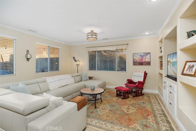 living room featuring built in shelves and crown molding