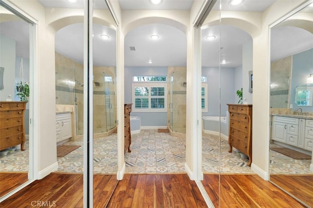 bathroom featuring vanity, an enclosed shower, and hardwood / wood-style flooring