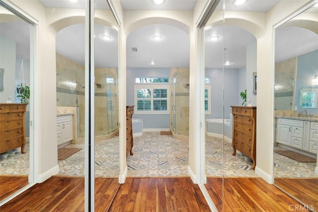 45600 La Cruz Dr, Temecula, CA 92590 - full bathroom featuring wood finished floors, vanity, a stall shower, and a tub to relax in