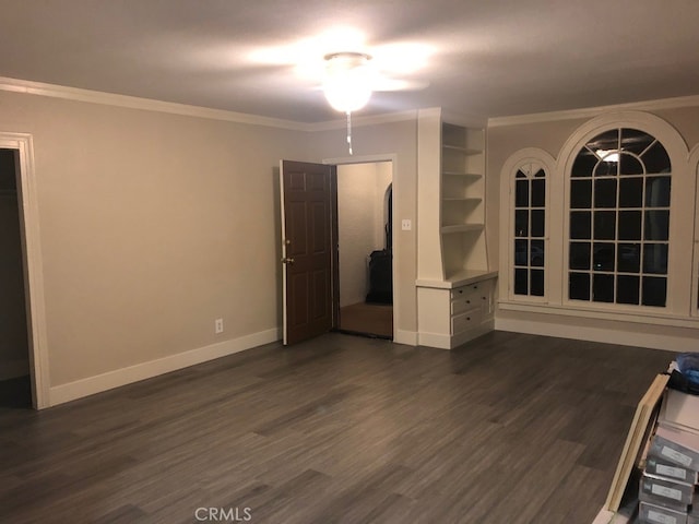 unfurnished room featuring ceiling fan, built in features, ornamental molding, and dark hardwood / wood-style floors