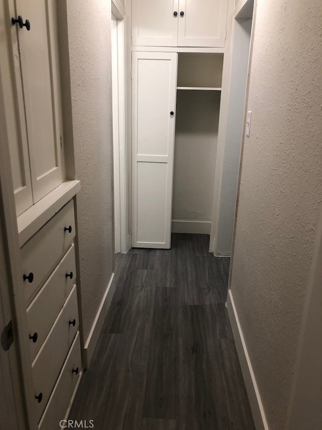 corridor with dark hardwood / wood-style floors