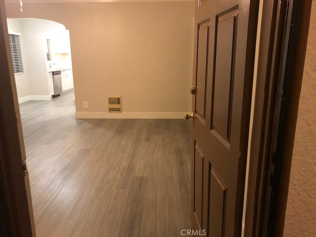 unfurnished room featuring sink and light wood-type flooring