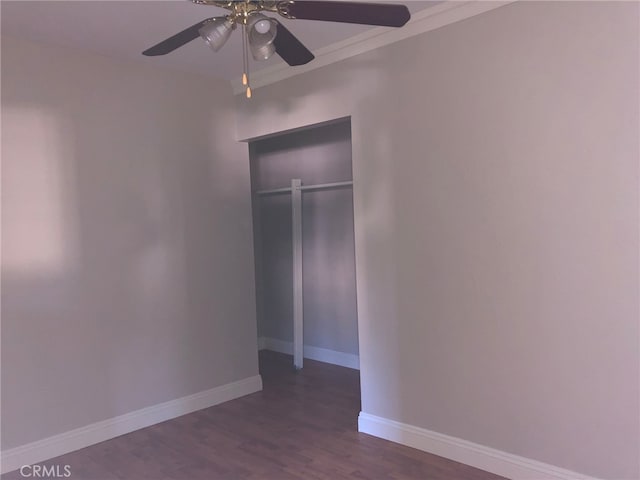 unfurnished bedroom with a closet, ceiling fan, ornamental molding, and dark hardwood / wood-style floors